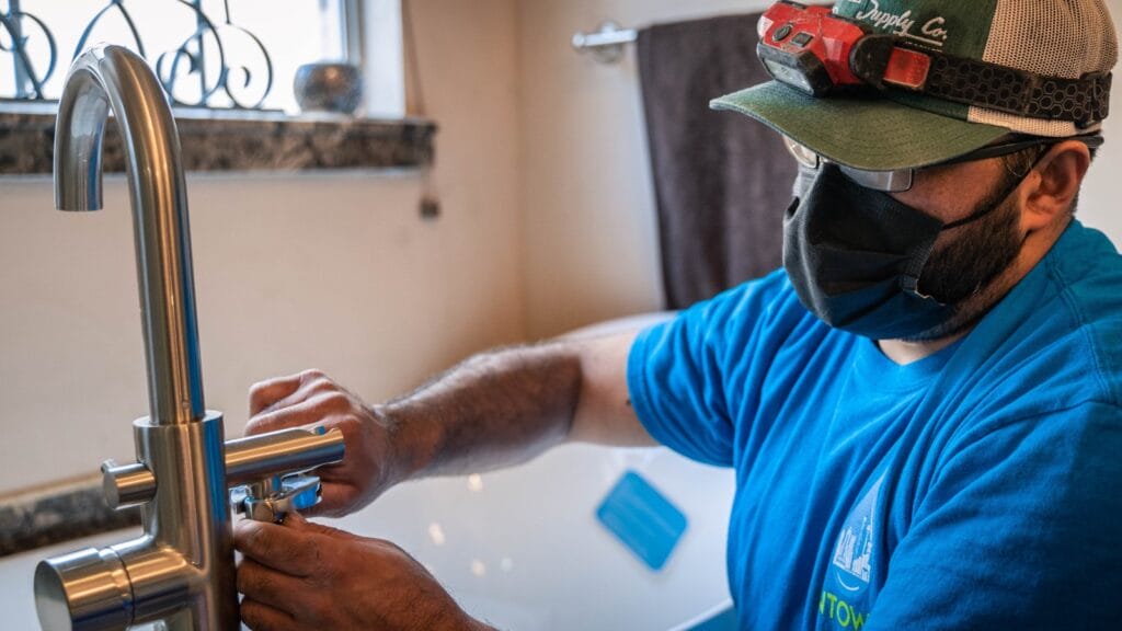  Intown Plumbing technician installing a water-efficient faucet as part of a home upgrade in Texas, supporting local water conservation rebates.
